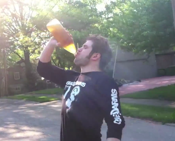 Bastion Crider of Grace at Arms (GRACE@ARMS) chugging a 40 oz Magnum high gravity malt liquor while wearing a Grace@Arms shirt.  This is a screen capture from a YouTube video.  All art and logos copyright Grace@Arms, Bastion Crider, Greg Crider LLC.